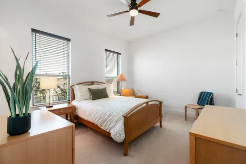 a bedroom with a bed and a potted plant