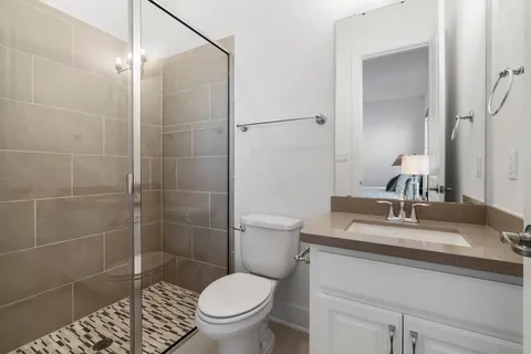 a bathroom with a sink toilet and shower