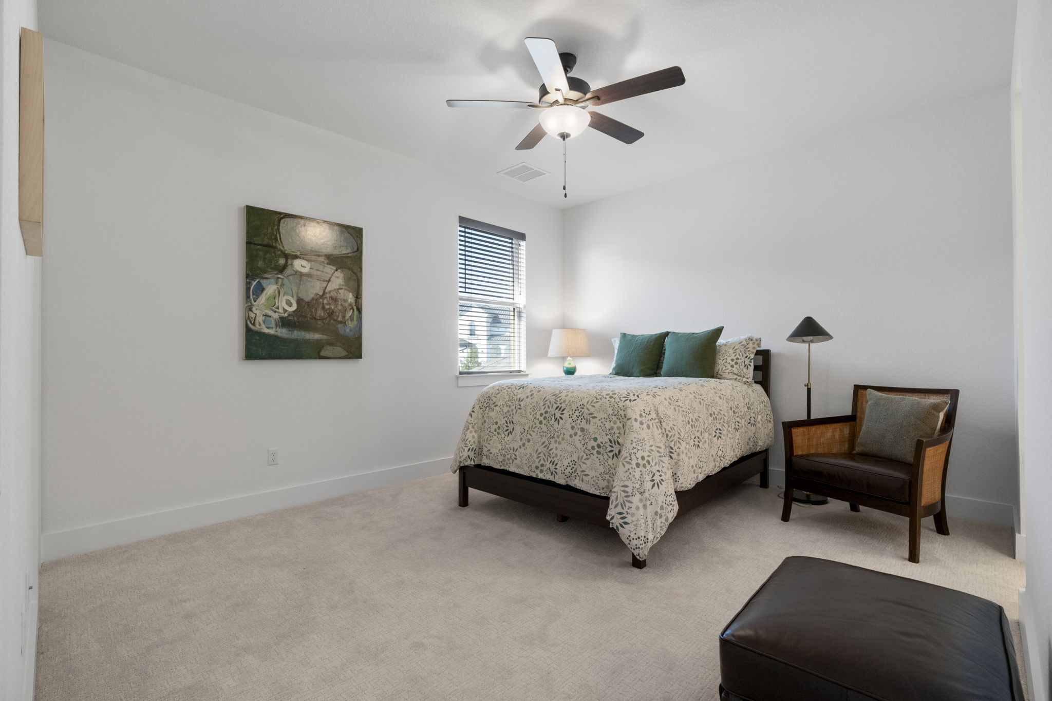 4704 Montorio Way Leander, TX 78641 - Photo 25 of 40 a bedroom with a bed a chair and a potted plant on a dresser