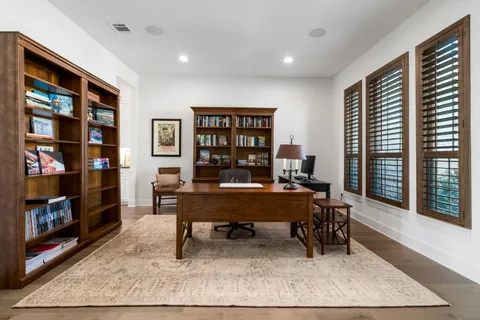 a living room with furniture and large window