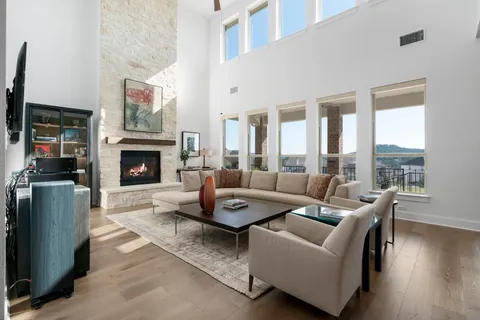 a living room with furniture a flat screen tv and a fireplace