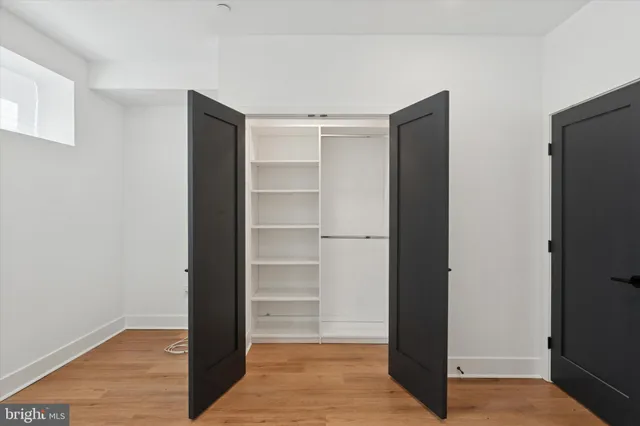 a view of walk in closet with empty racks