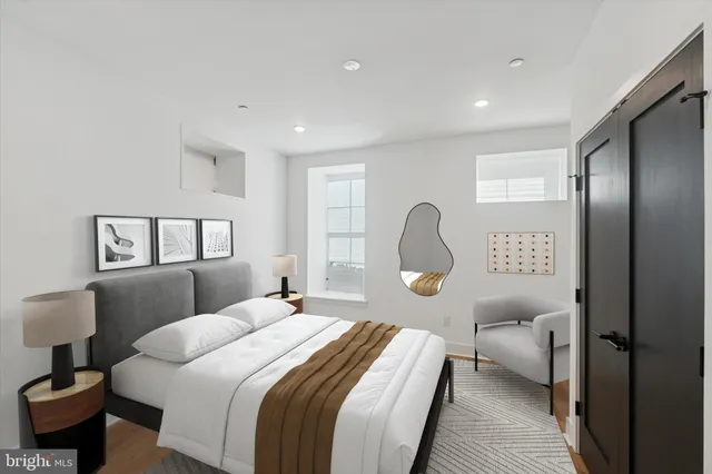 a bedroom with a bed and a potted plant