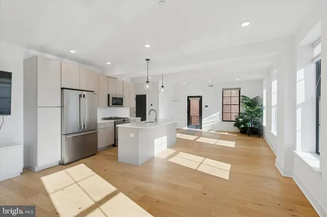 a view of kitchen with refrigerator stove microwave and cabinets