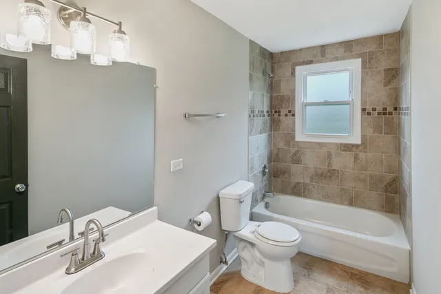 a bathroom with a toilet a sink and a bathtub