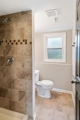 a bathroom with a toilet sink and shower