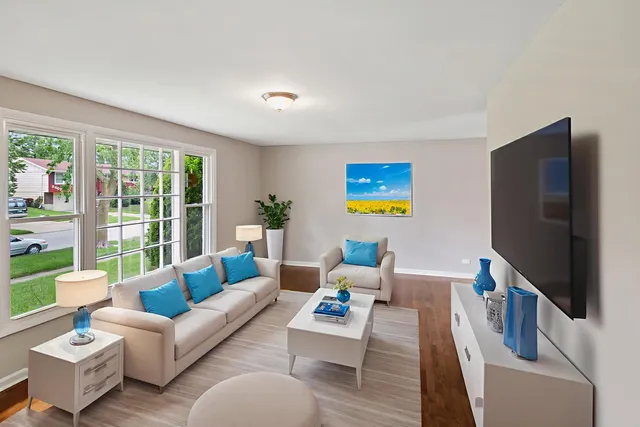 a living room with furniture wooden floor and a flat screen tv
