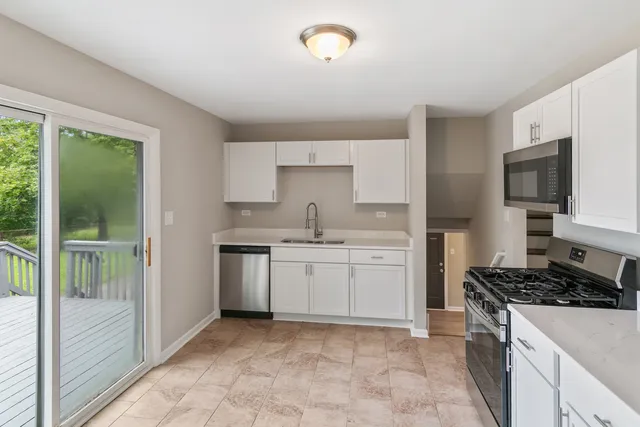 a kitchen with a sink stove and cabinets