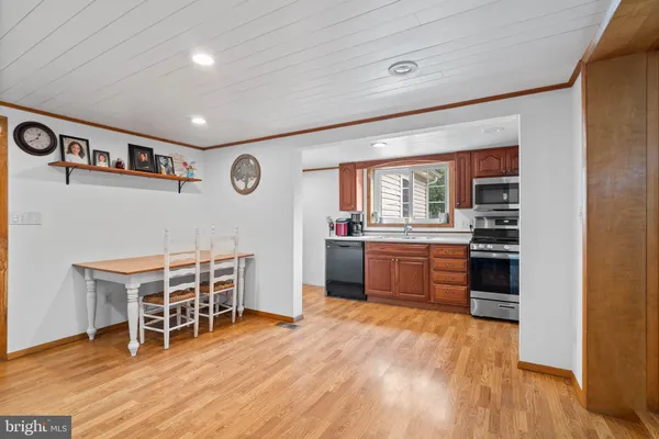 a room with furniture a wooden floor and a window