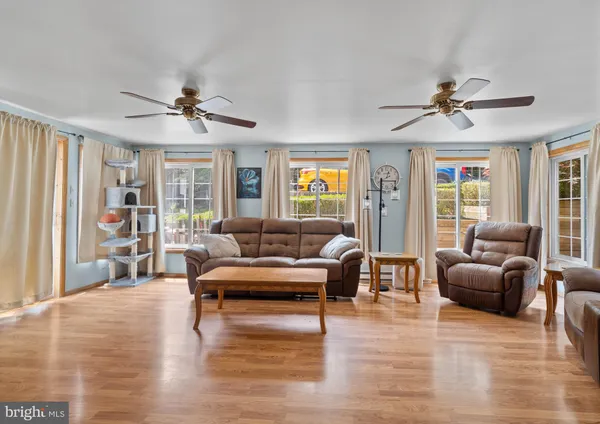 a living room with furniture dining area and a window
