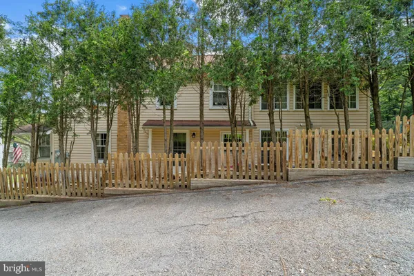 a view of a house with a wooden fence