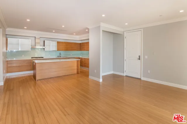 a view of kitchen with wooden floor and electronic appliances