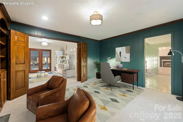 a living room with furniture and a chandelier
