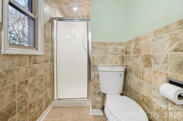 a bathroom with a toilet and a shower