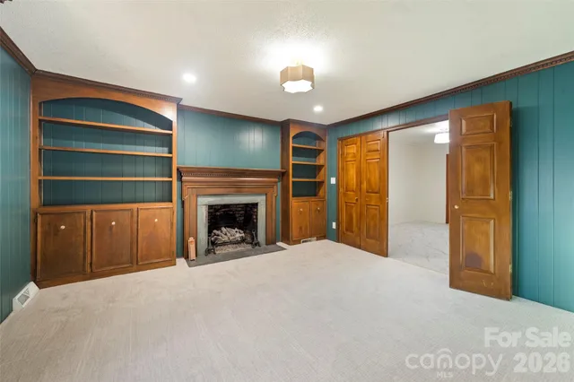 a living room with furniture a flat screen tv and a large window