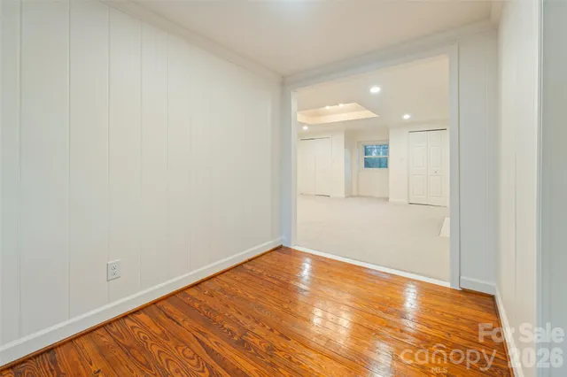 a view of empty room with wooden floor