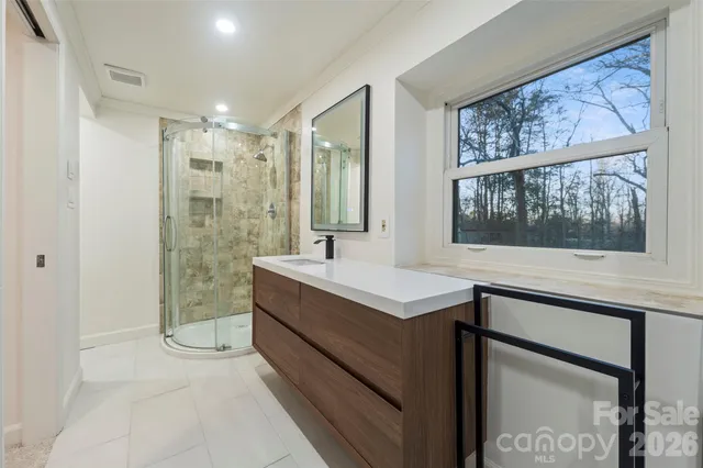 a bathroom with a sink mirror and a bathtub