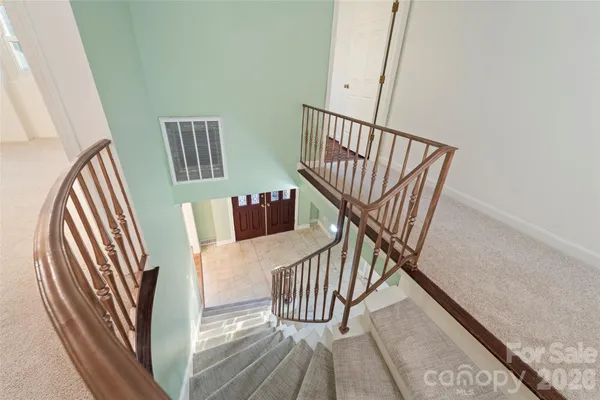 a view of entryway with wooden floor and stairs
