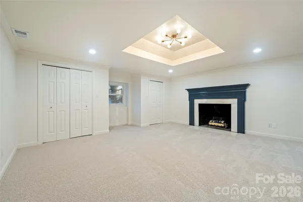 a view of an empty room with a fireplace