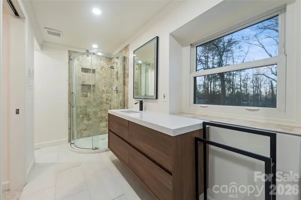 a bathroom with a sink mirror and a bathtub