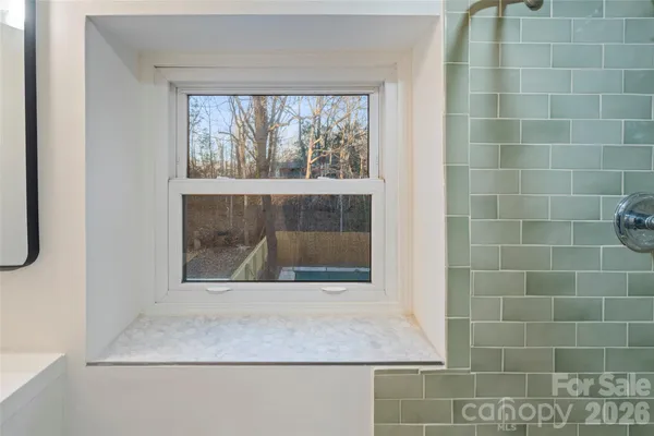 a bathroom with a granite countertop sink and window