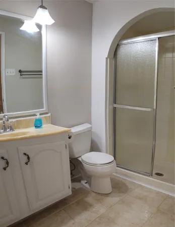 a bathroom with a toilet and a shower