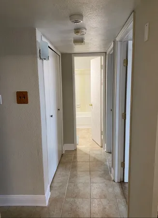 a view of a room with wooden floor and cabinets
