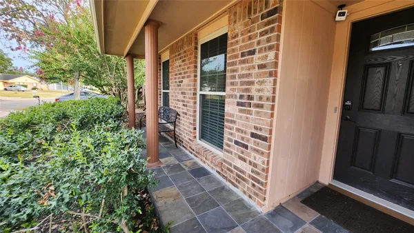 a view of a door and brick walls