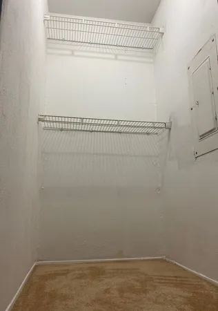 an empty room with a window and a ceiling fan