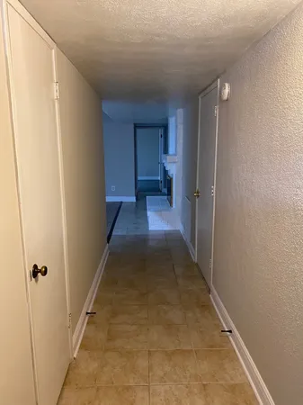 a view of kitchen living room with cabinets and fireplace
