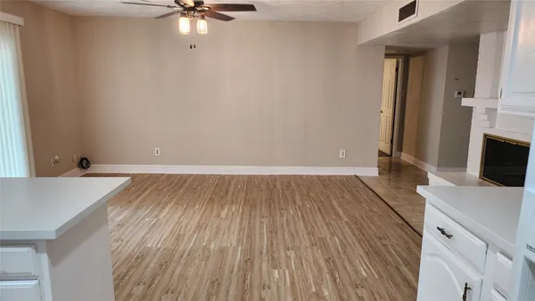 a view of a kitchen with a sink and dishwasher a oven with wooden floor
