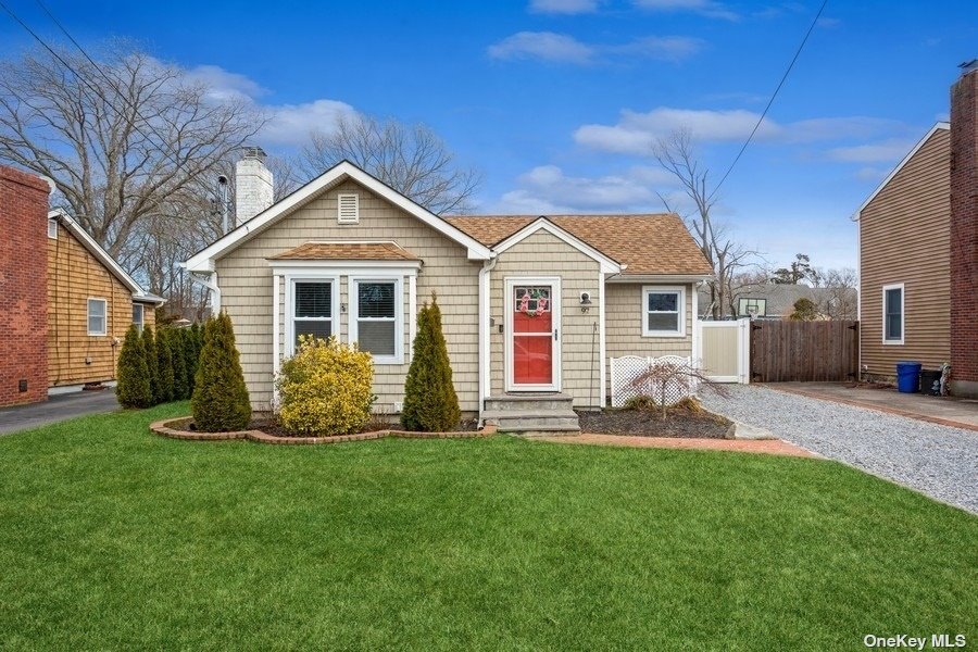 97 Washington Avenue Patchogue, NY 11772 - Photo 1 of 1 a front view of a house with a yard and porch