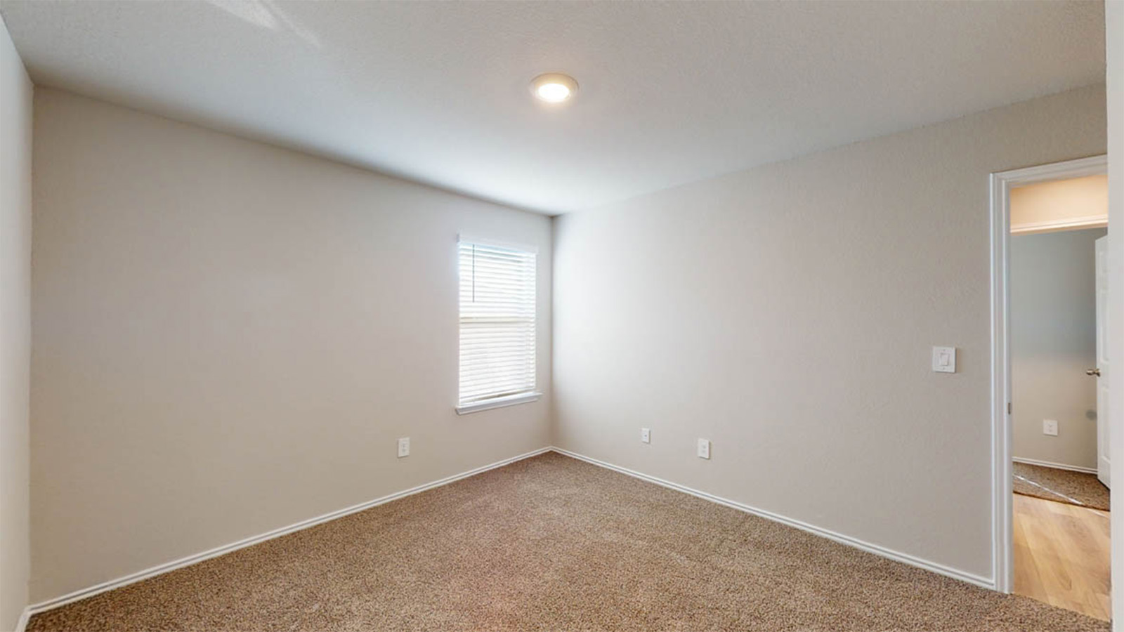 1407 Victory Rnch Trail Killeen, TX 76549 - Photo 18 of 24 A well-lit room featuring neutral tones and a warm, inviting carpet underfoot.