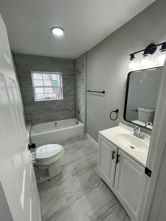 a bathroom with a sink toilet and tub