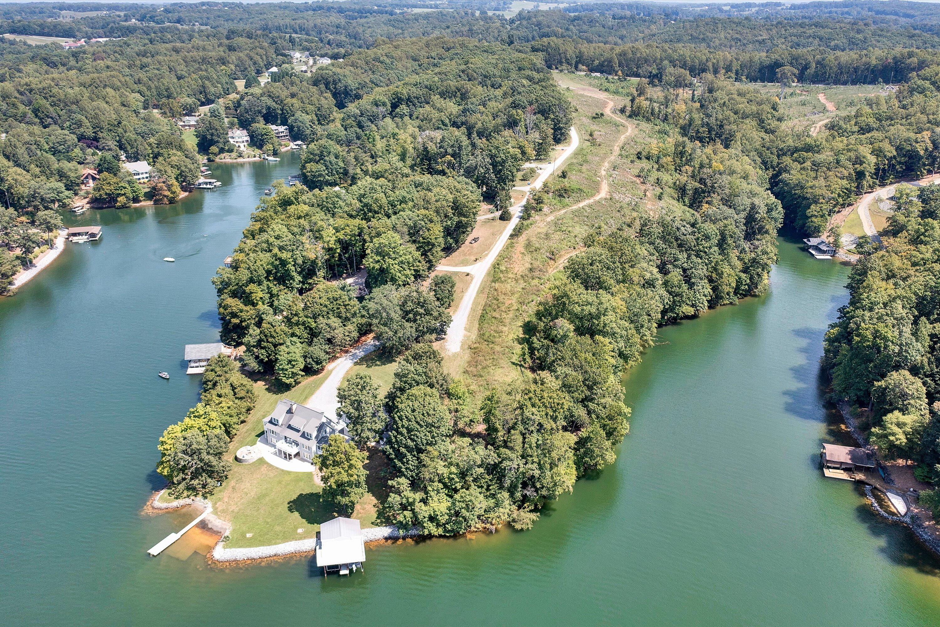 an aerial view of residential house with outdoor space and lake view