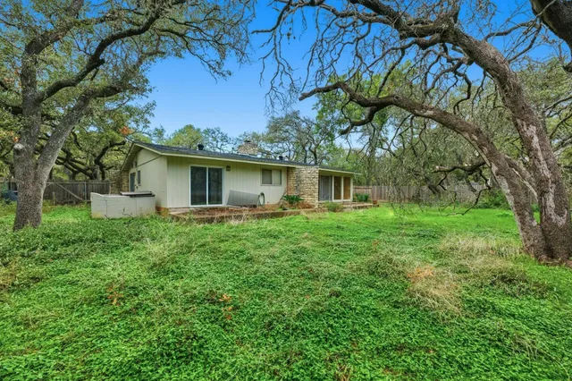 a green field with lots of trees in it