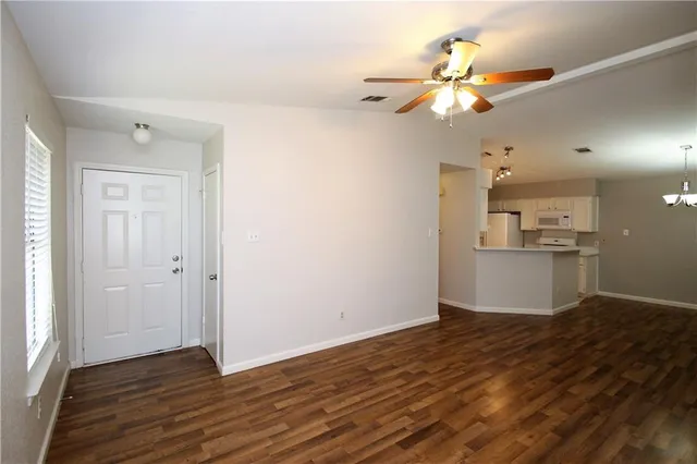 a view of a kitchen with wooden floor and a kitchen space