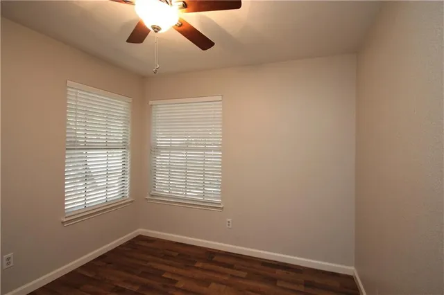 a view of wooden floor and windows in a room