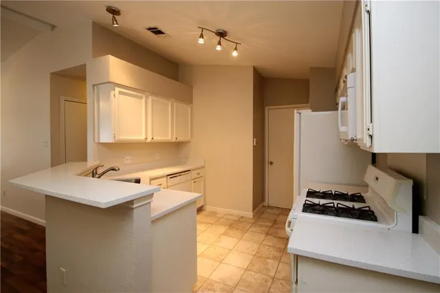 a kitchen with a stove a sink and a refrigerator