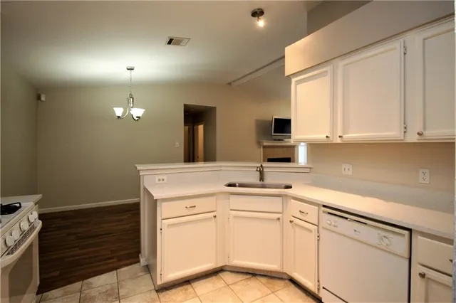 a kitchen with cabinets appliances a sink and a window