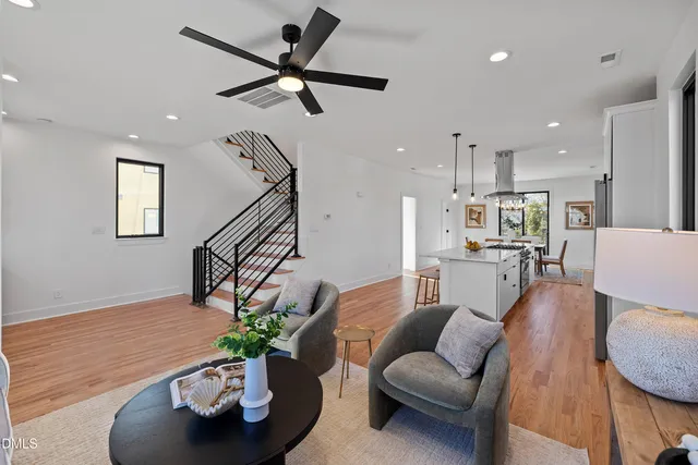 a kitchen with a table chairs refrigerator and cabinets
