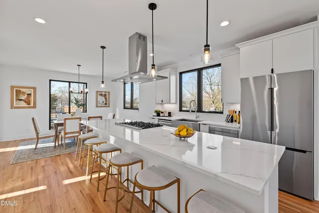 a stove top oven sitting inside of a kitchen