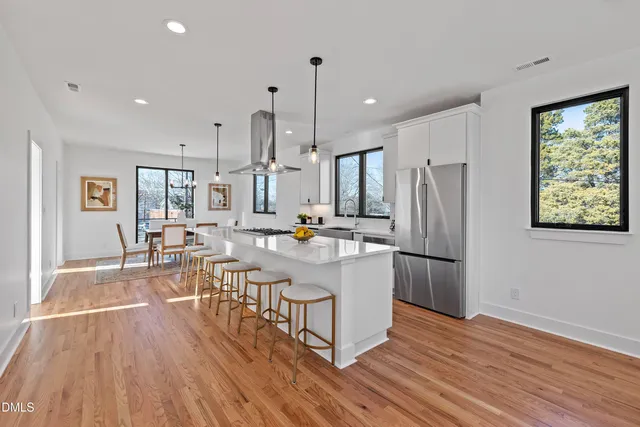 a kitchen with stainless steel appliances a stove sink and cabinets