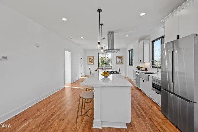 a view of a hallway with wooden floor and stairs