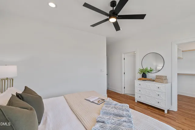 a view of a hallway with wooden floor and a window