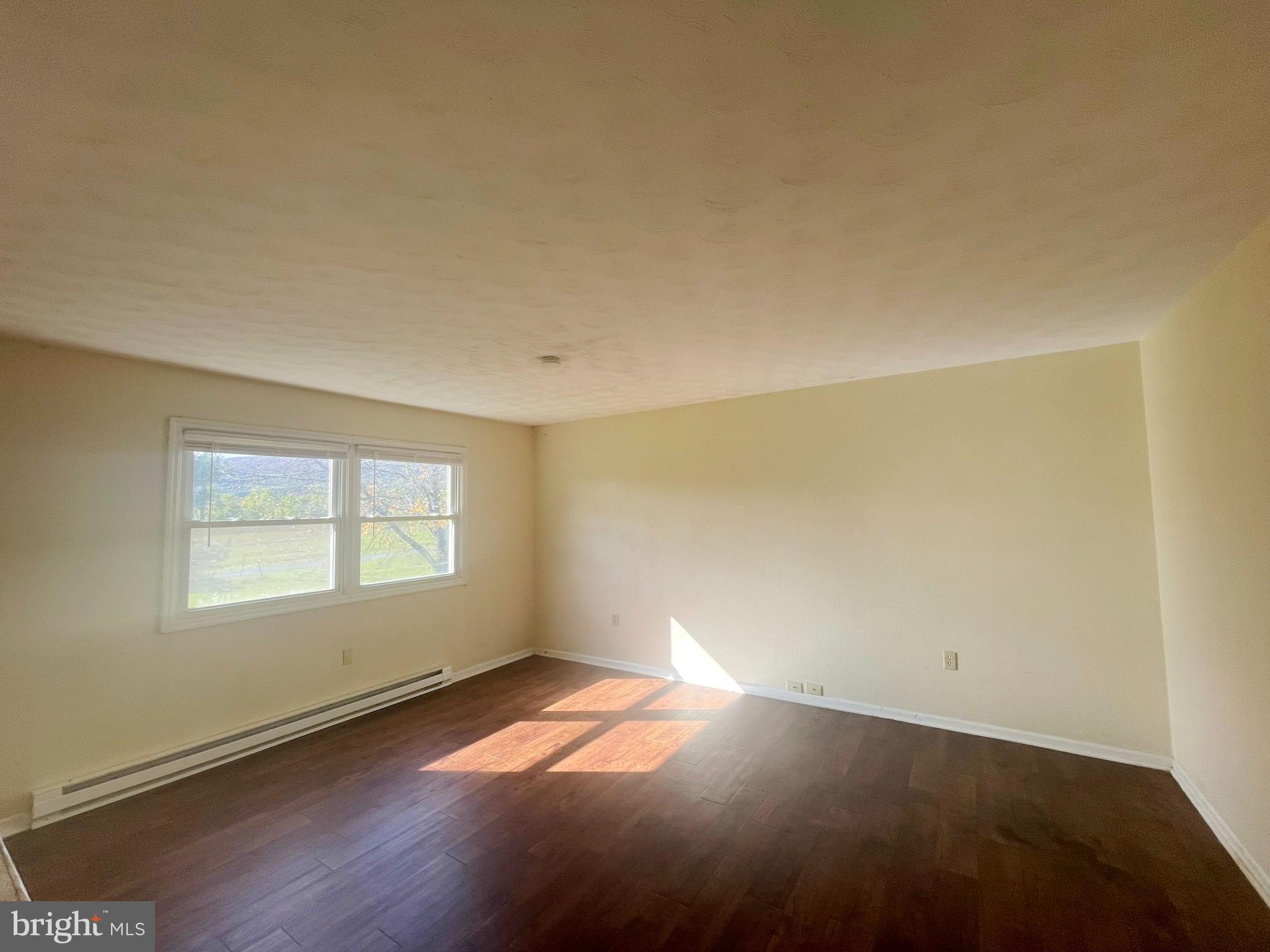 649 Shed Road Newville, PA 17241 - Photo 4 of 20 an empty room with wooden floor and windows
