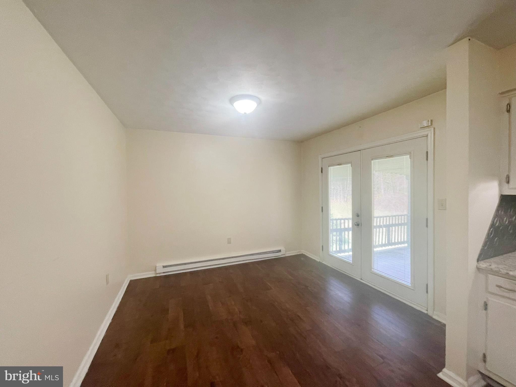 649 Shed Road Newville, PA 17241 - Photo 9 of 20 an empty room with wooden floor and windows