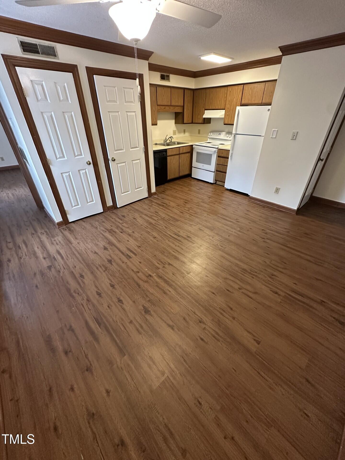 3605 Helix Court, Unit 201 Raleigh, NC 27606 - Photo 2 of 7 a view of a kitchen with wooden floor and electronic appliances