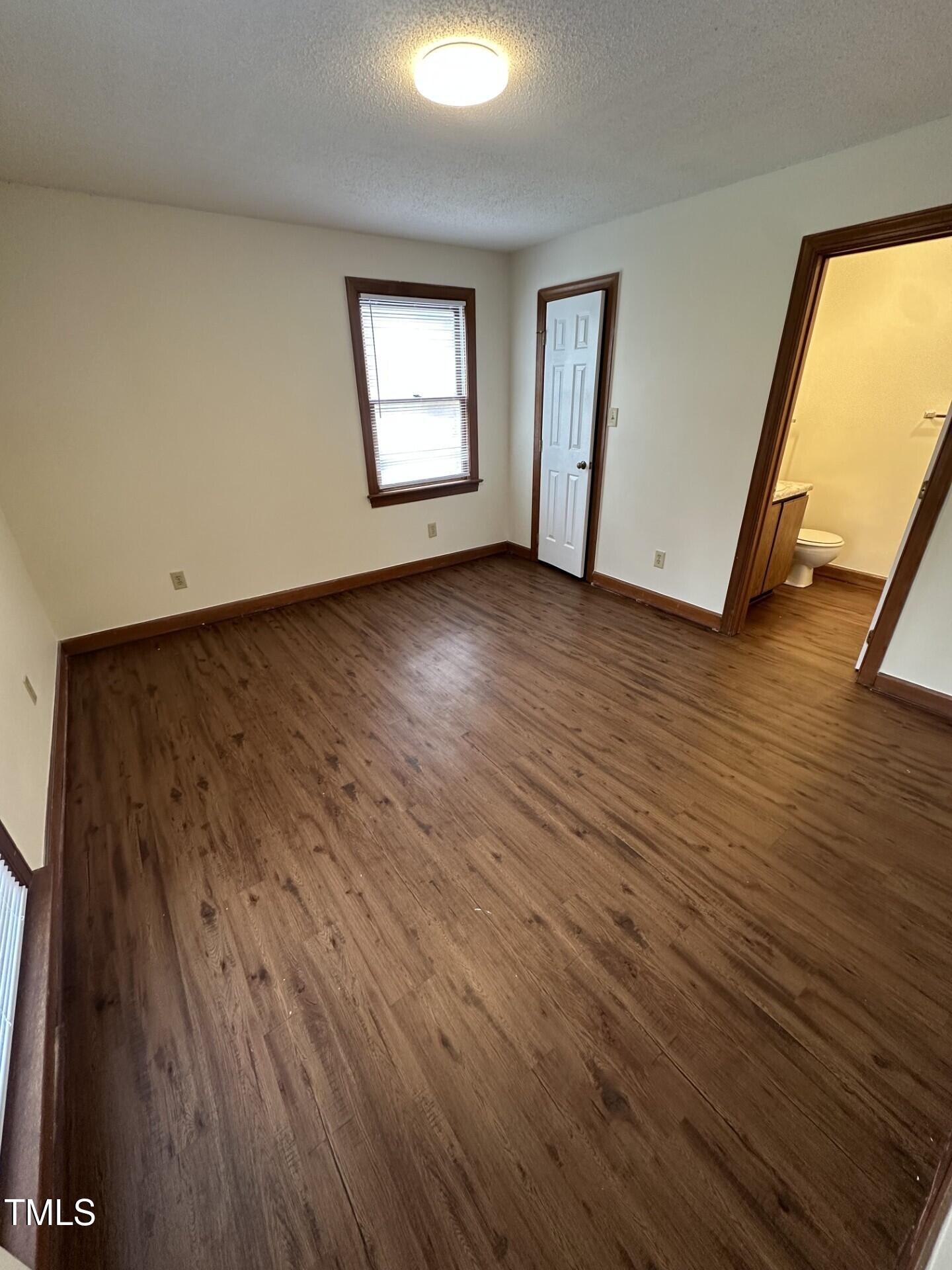 3605 Helix Court, Unit 201 Raleigh, NC 27606 - Photo 5 of 7 a view of a room with wooden floor and windows
