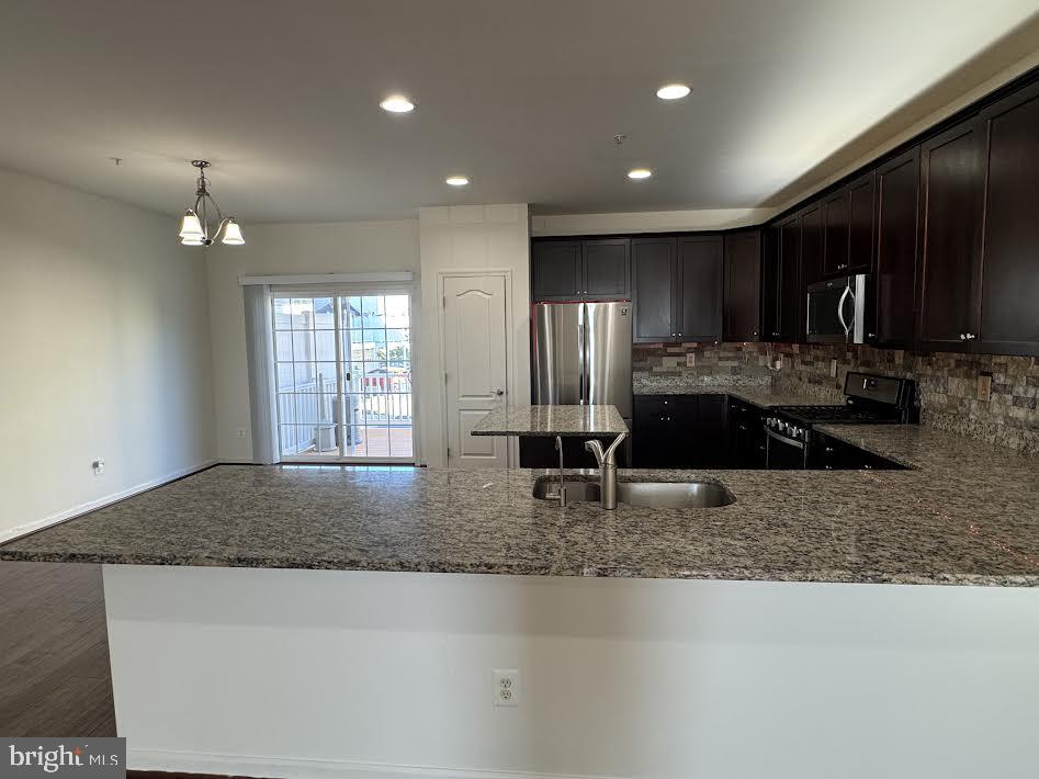 7806 Taggart Court Elkridge, MD 21075 - Photo 14 of 21 a large kitchen with kitchen island granite countertop a large counter top stainless steel appliances and cabinets